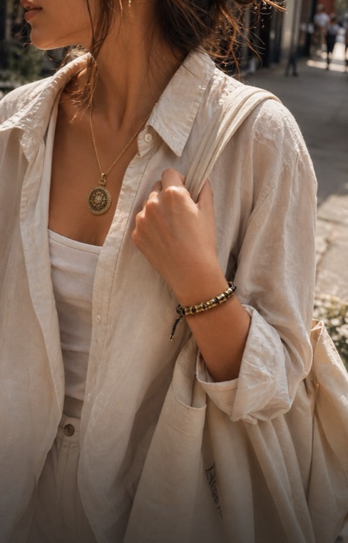 Luck Comes bracelet worn with a daily outfit