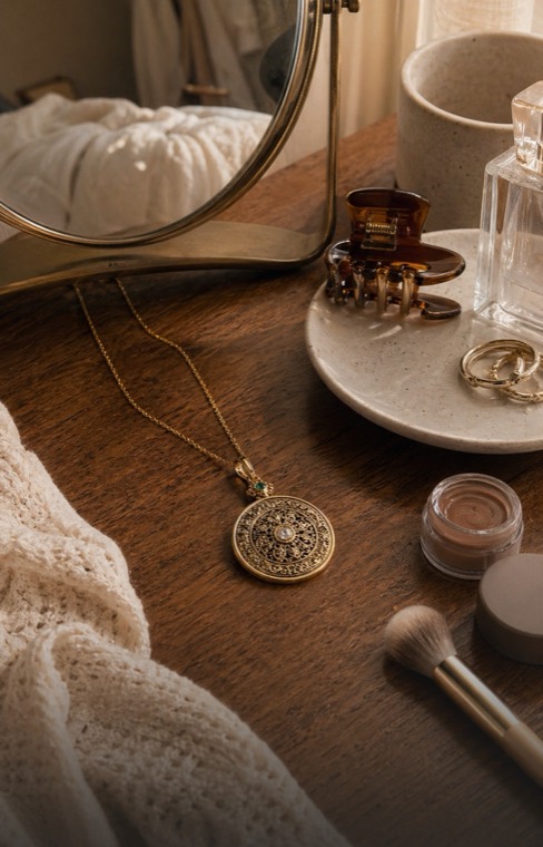 Luck Comes pendant necklace on a vanity table